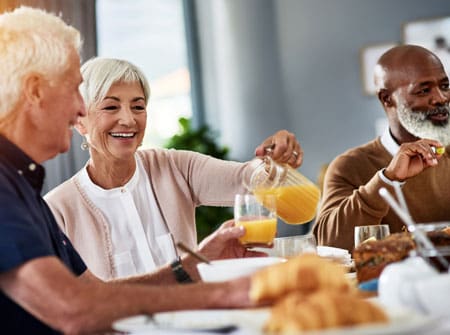 Diverse group of seniors enjoying breakfast together