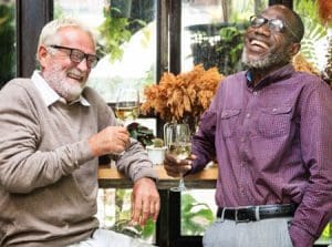 senior men laughing and enjoying white wine