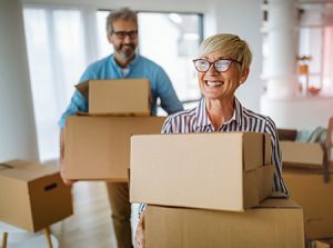 happy senior couple in love moving in new home