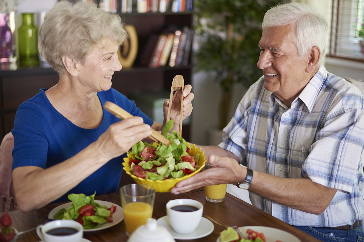 seniors enjoying a healthy breakfast on the summer day