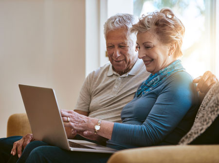 Senior couple reviewing information on a laptop computer