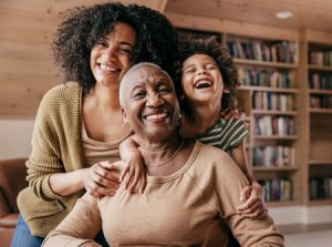 3 generations of an ethnic family smiling and laughing