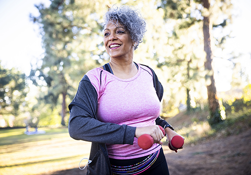 Senior Woman Stretching and Exercising with Weights