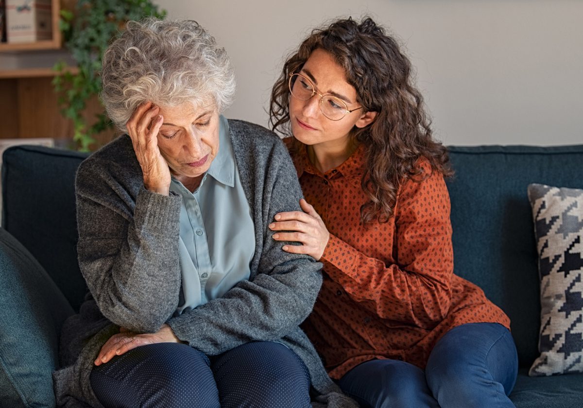 Young woman consoling upset grandmother