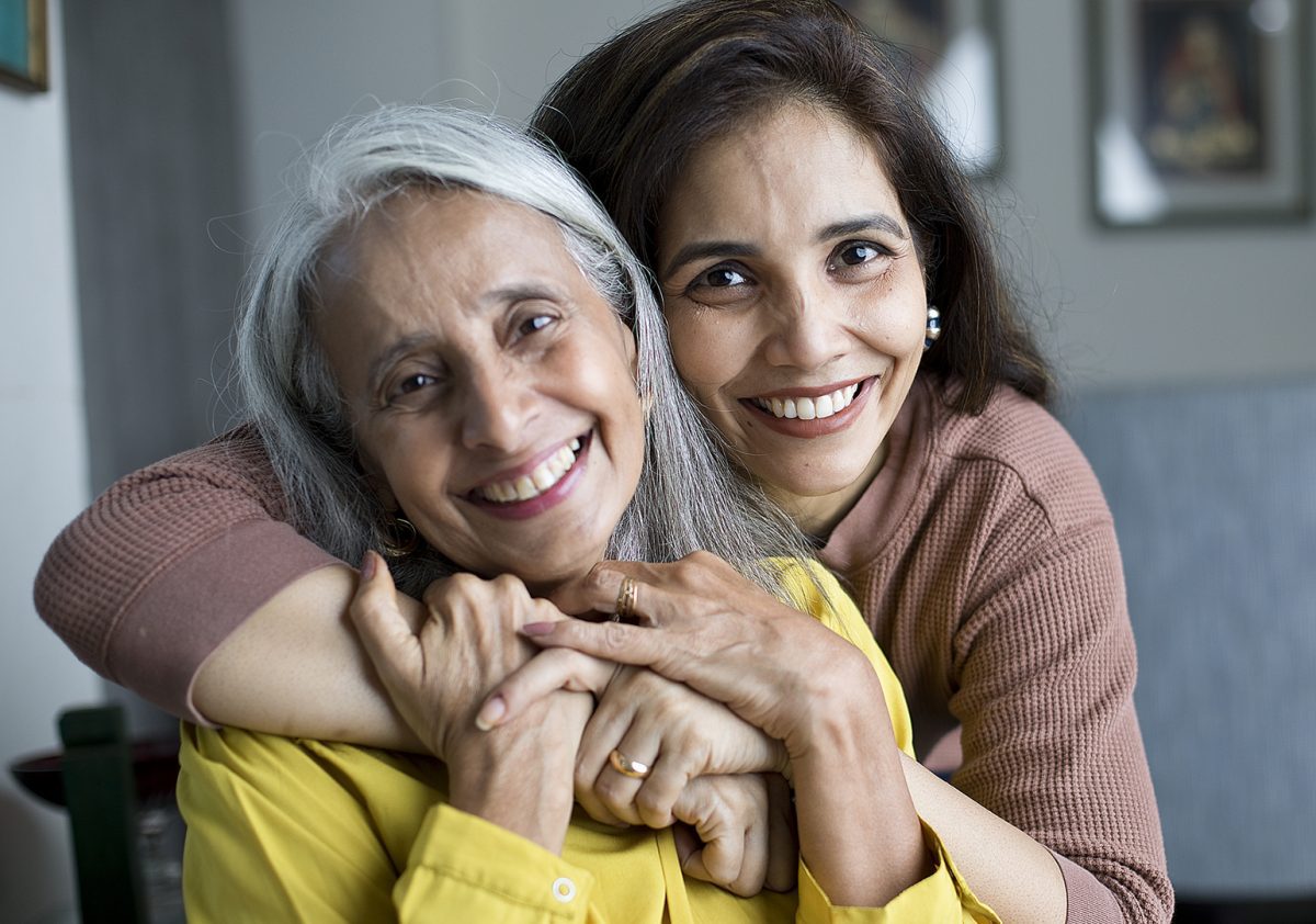 Happy woman hugging her senior mother