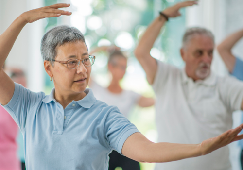 group of seniors doing tai chi together