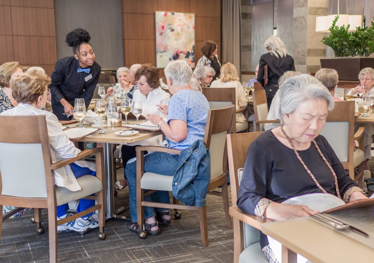 seniors sitting down for dinner in the waterstone dining room