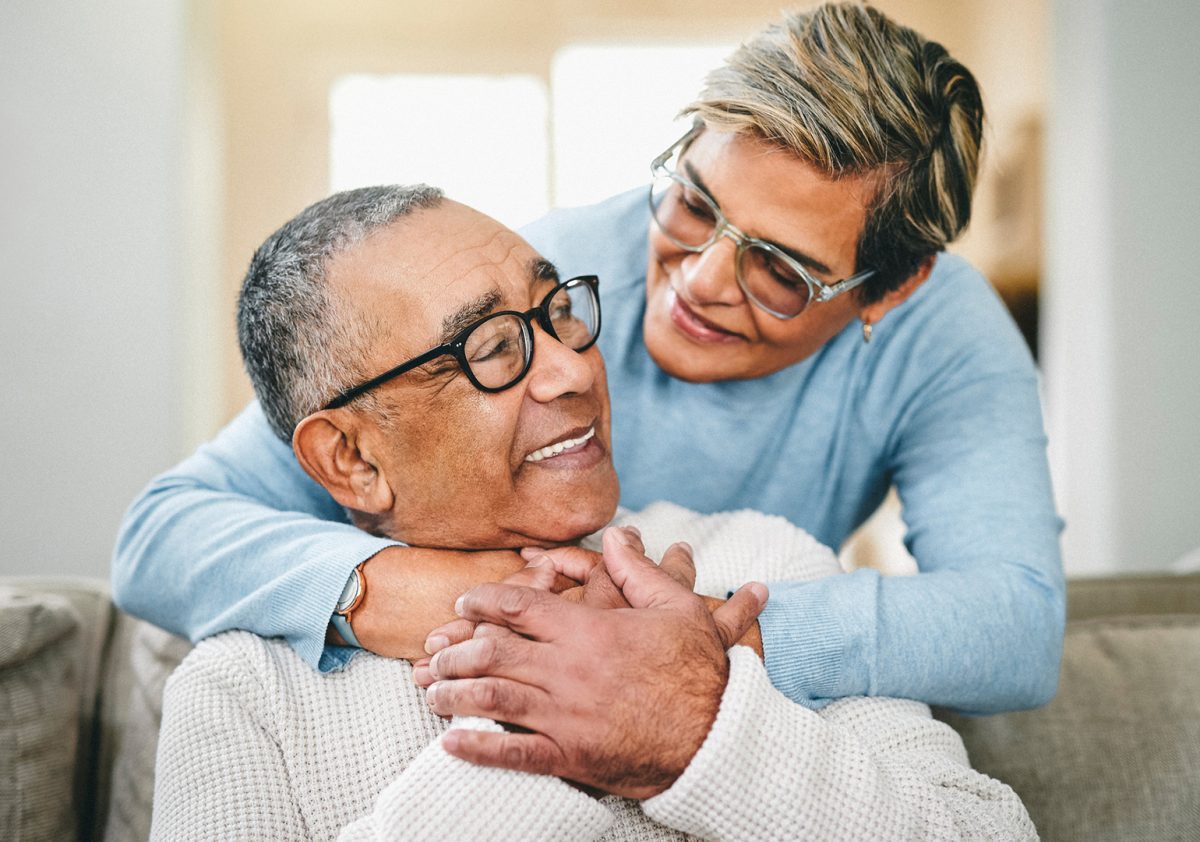 Shot of a senior woman hugging her husband at home