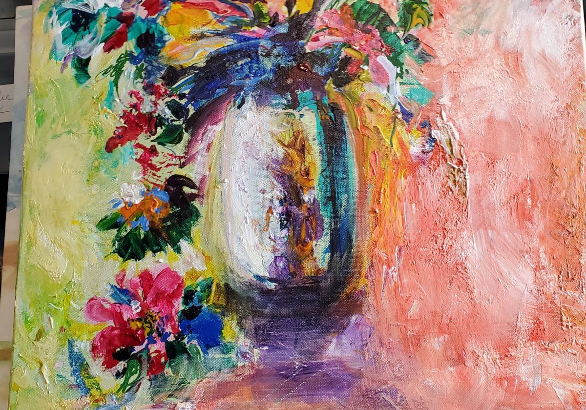 shot of a watercolor painting of a flower vase, sitting on a wood easel