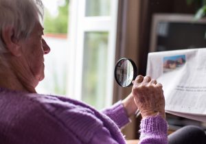 Senior woman reading morning newspaper