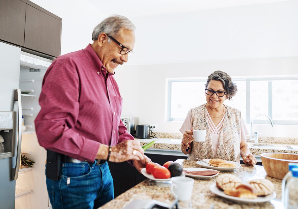 Senior married couple eating healthy food for breakfast.