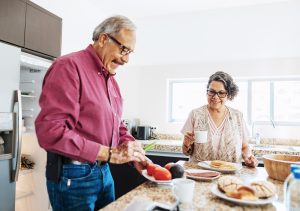 Senior married couple eating healthy food for breakfast.