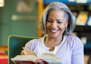 Senior woman enjoys reading in the library