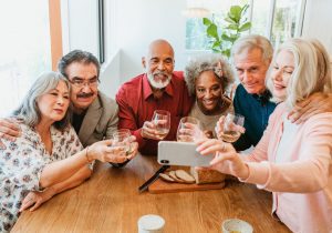 Woman taking selfie with friends at brunch party