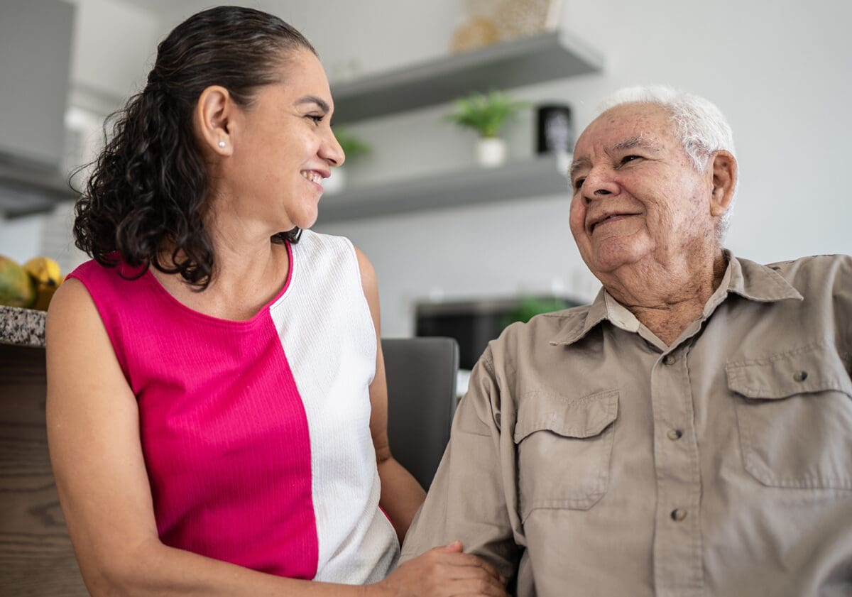 Senior man and his daughter talking at home