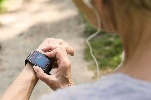 senior woman checking her heart rate on her smart watch