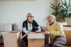 Senior couple unpacking cardboard boxes