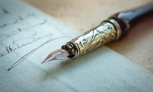 Fountain pen on an antique handwritten letter