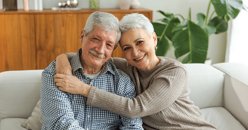Couple sitting on a sofa.