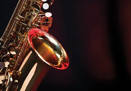 close up of a saxophone on a lit stage