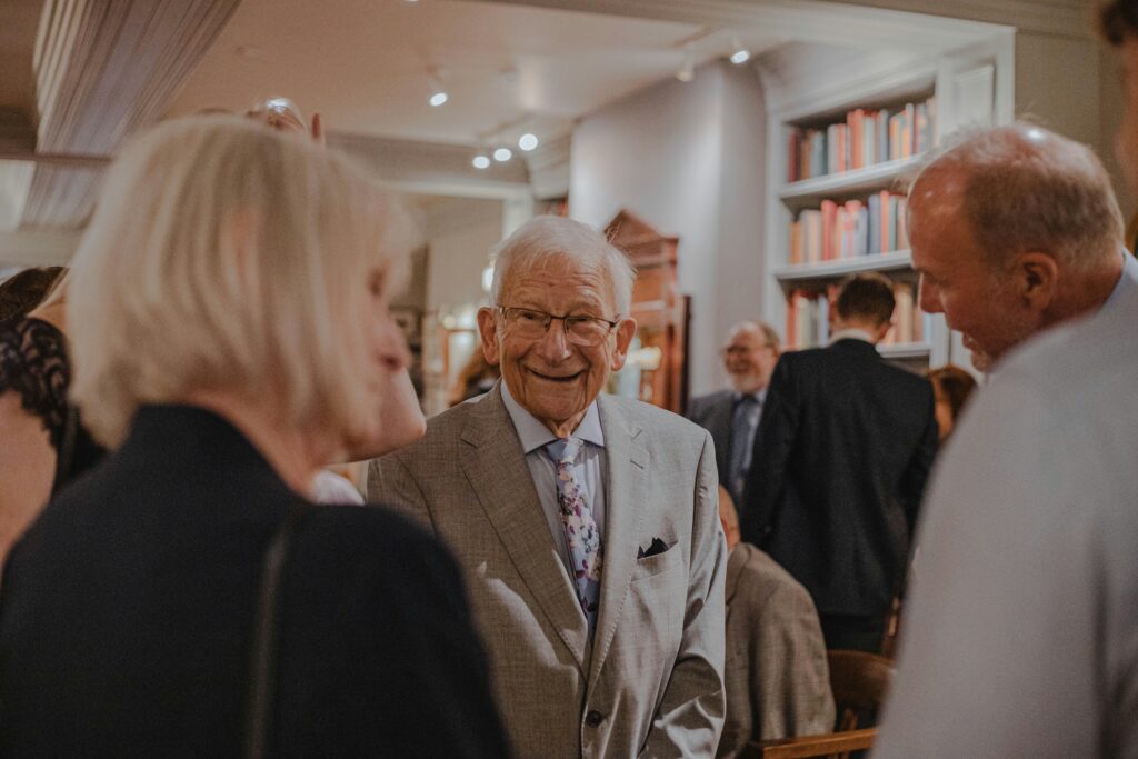 Hobbies for seniors: A well-dressed older man socializes with others