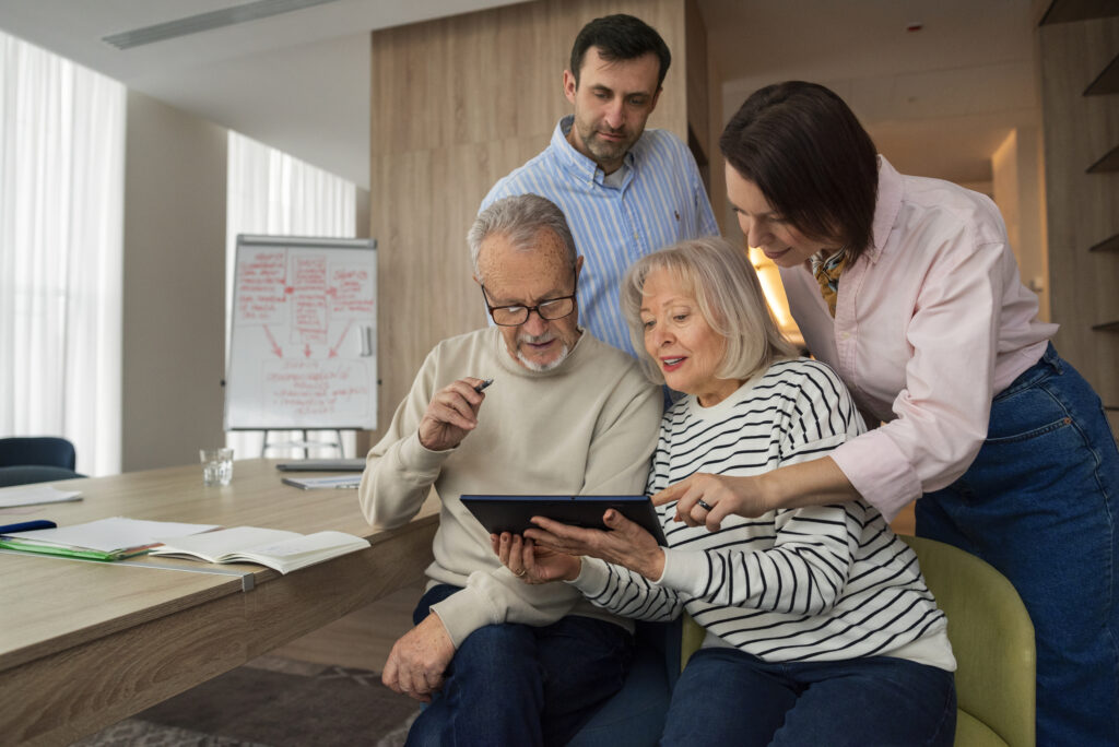 Hobbies for seniors: a younger and older couple study using a tablet.
