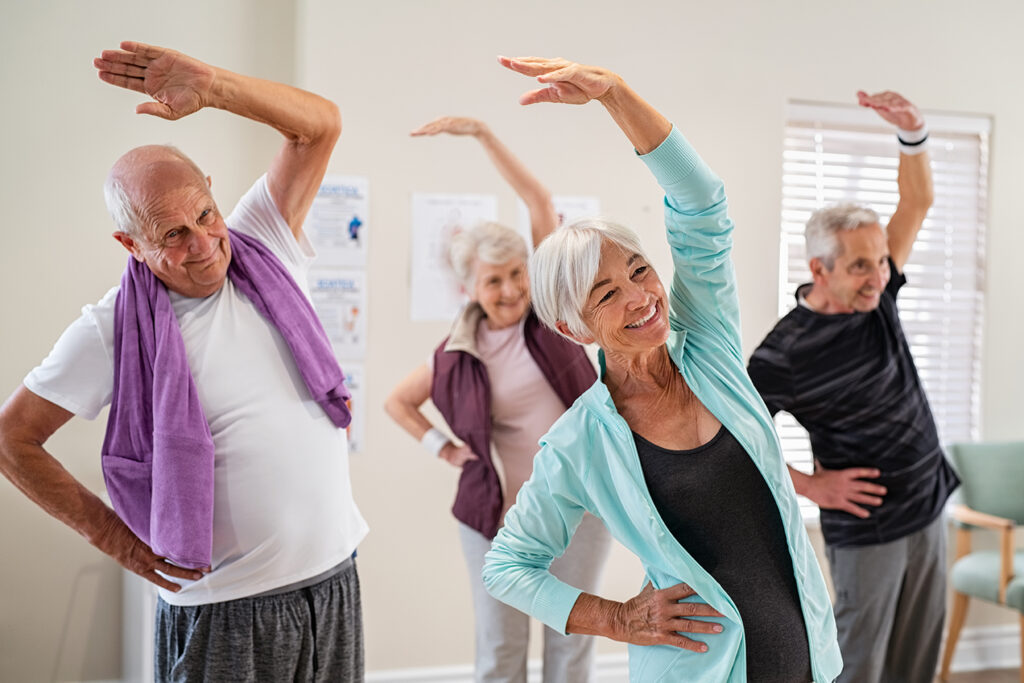 seniors practice yoga, angle pose