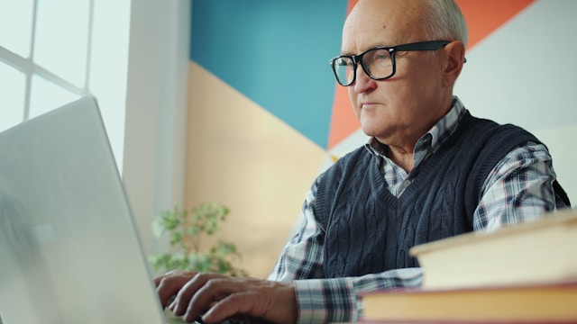 A senior looking concerned on a laptop